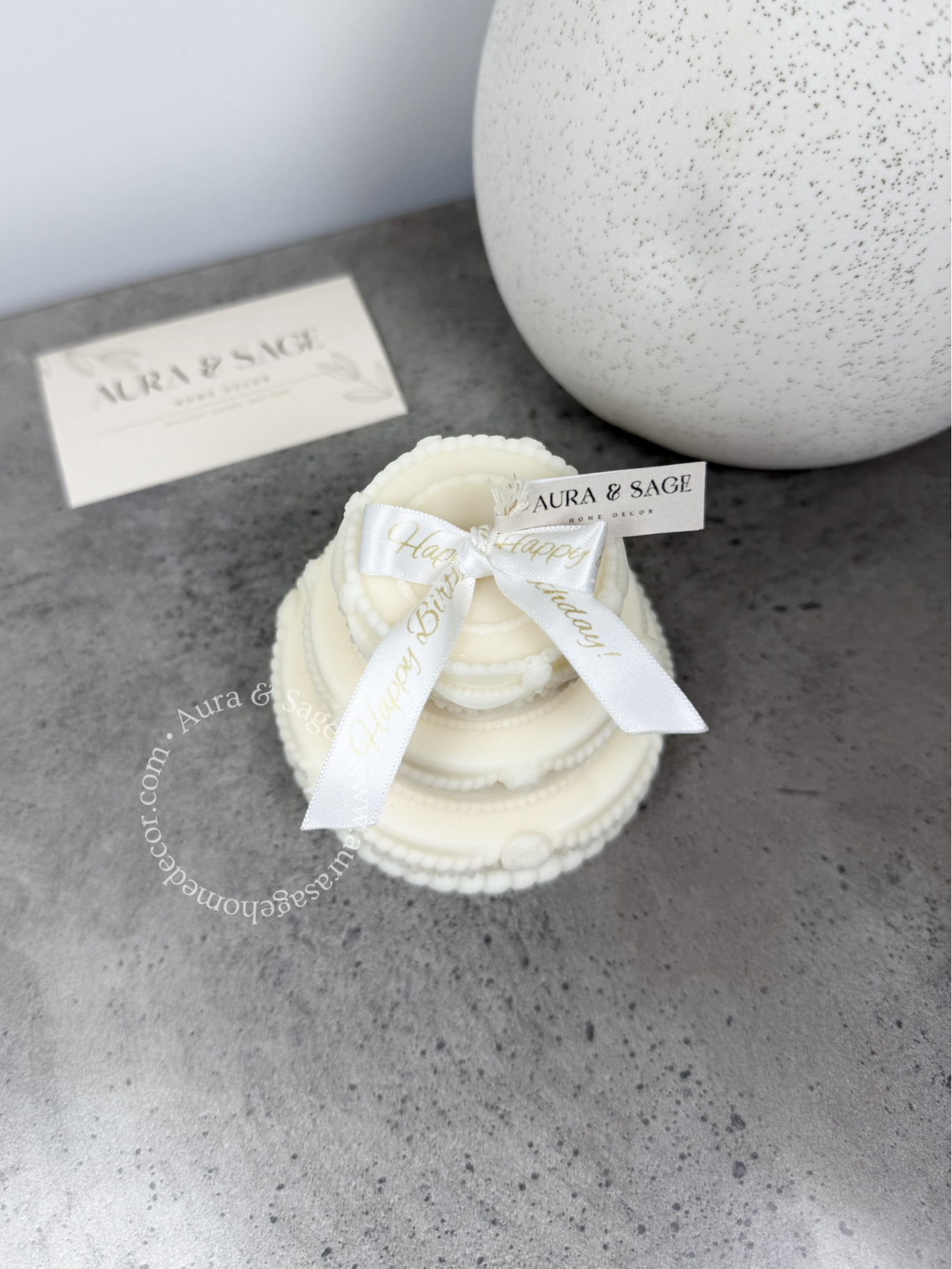 Tripled layer cake candle with white bow, birthday gift.