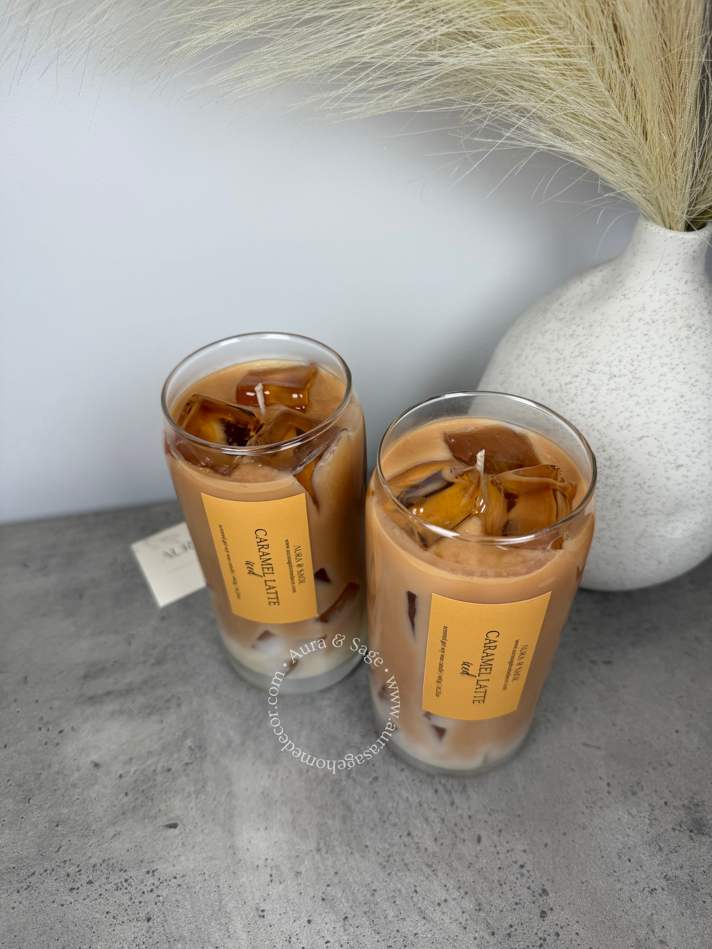 Caramel coffee latte drink-inspired candle in glass container.