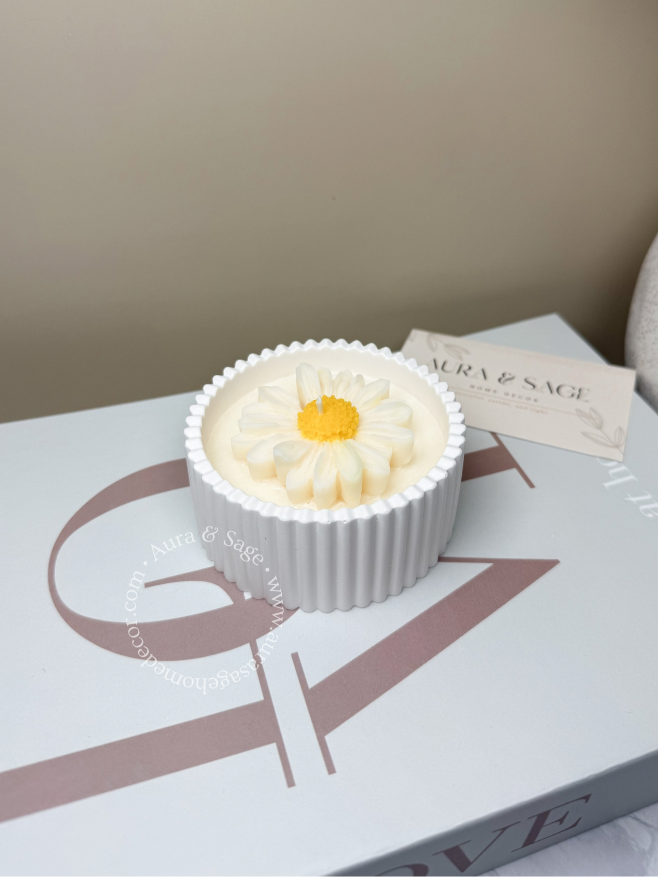 Daisy floral design scented soy wax candle in white jar.