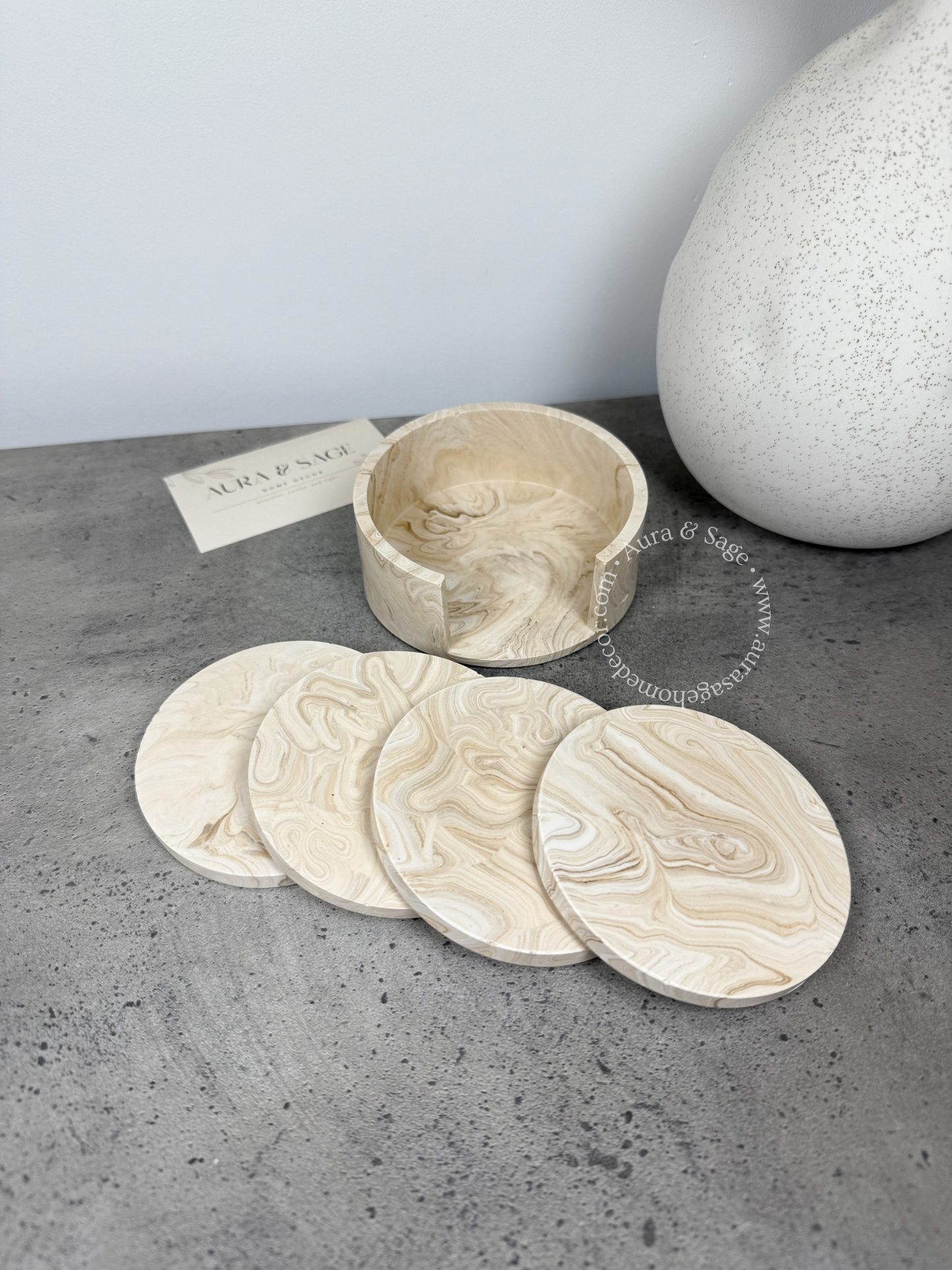 Set of stone coasters with a holder in beige marble.