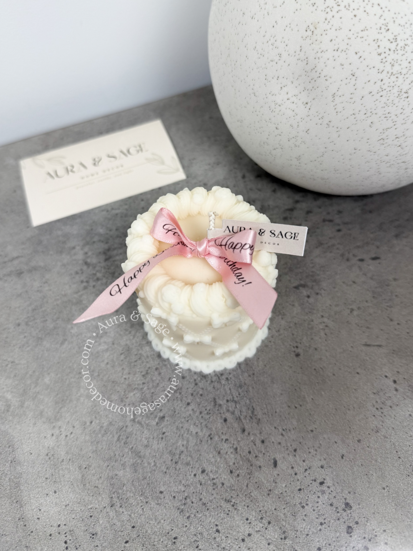 Small decorative cake candle with bows.