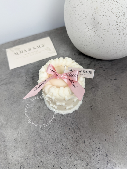 Small decorative cake candle with bows.