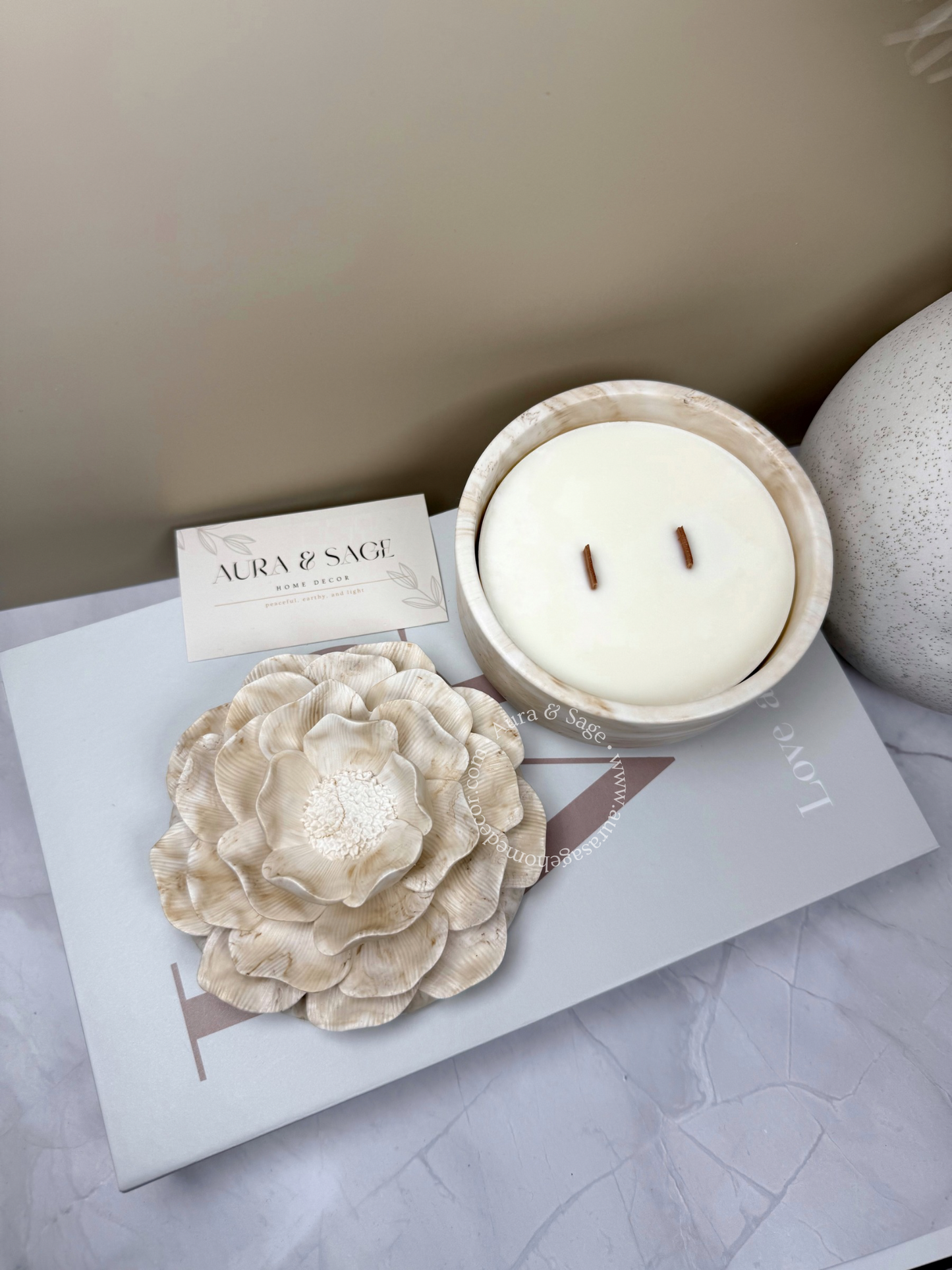 Candle in a decorative flower-shaped container.