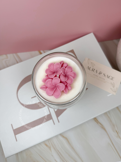 Cherry blossom flower inspired candle in glass container.