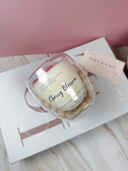 Floral candle in double wall glass container.