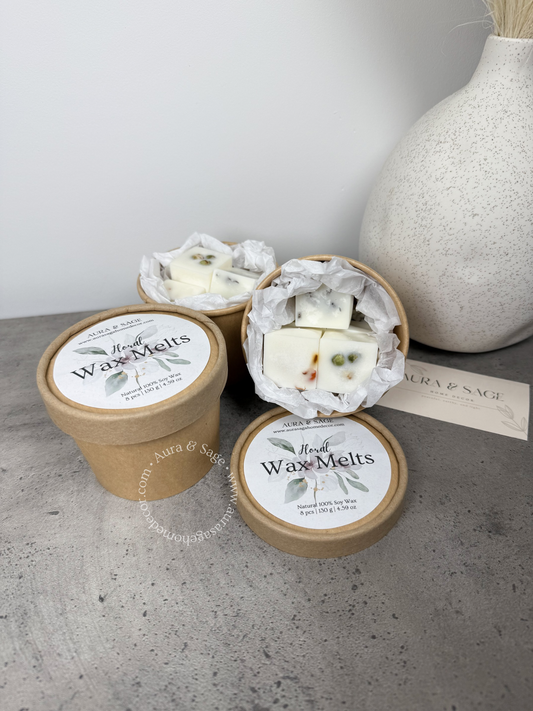 Containers of wax melts with dried florals.