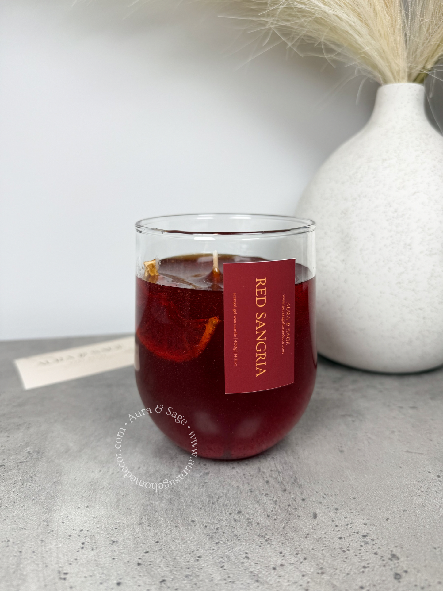 Reg sangria drink-inspired candle in glass container.