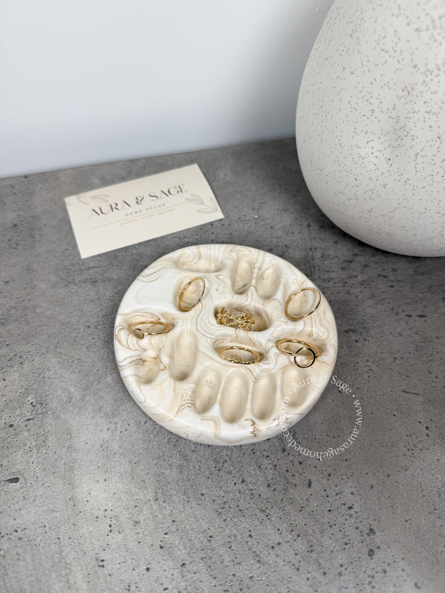 Beige marble jewelry rings holder.