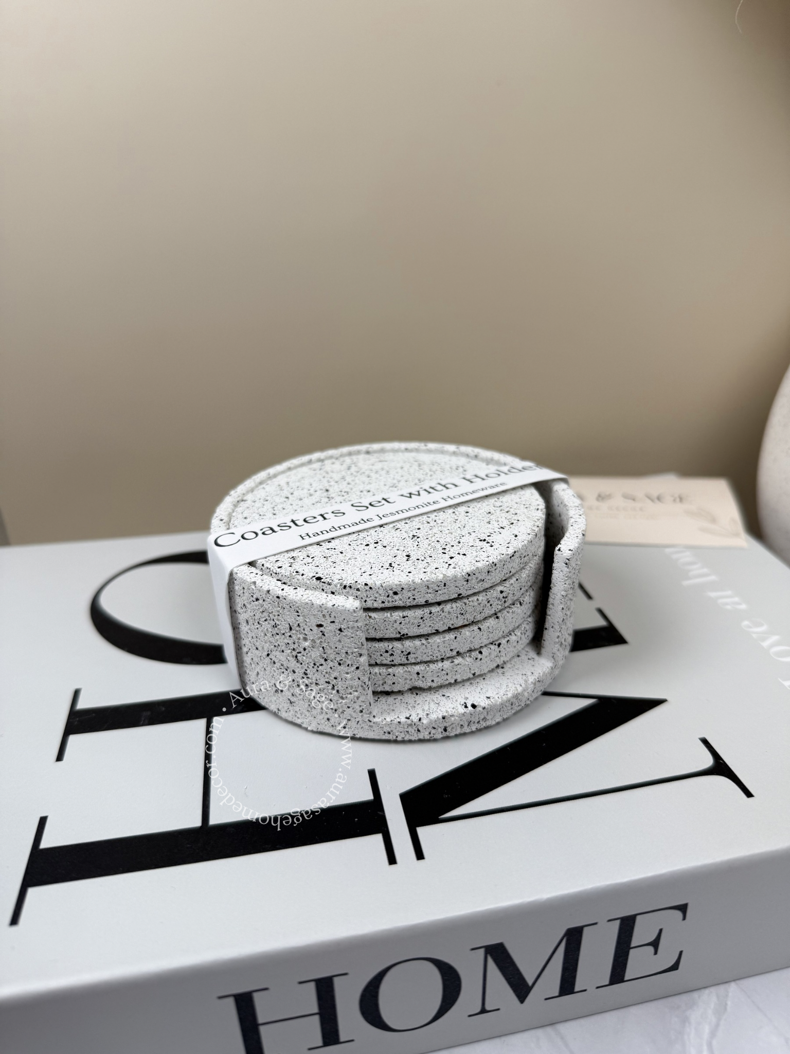 Set of silver grey granite stone coasters on a book